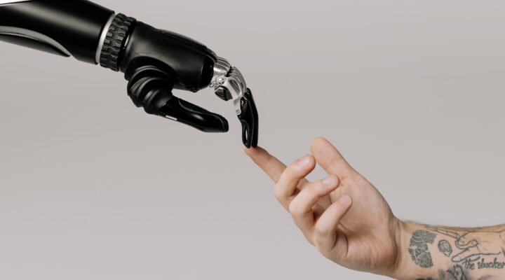 Robotic hand touching a person's hand