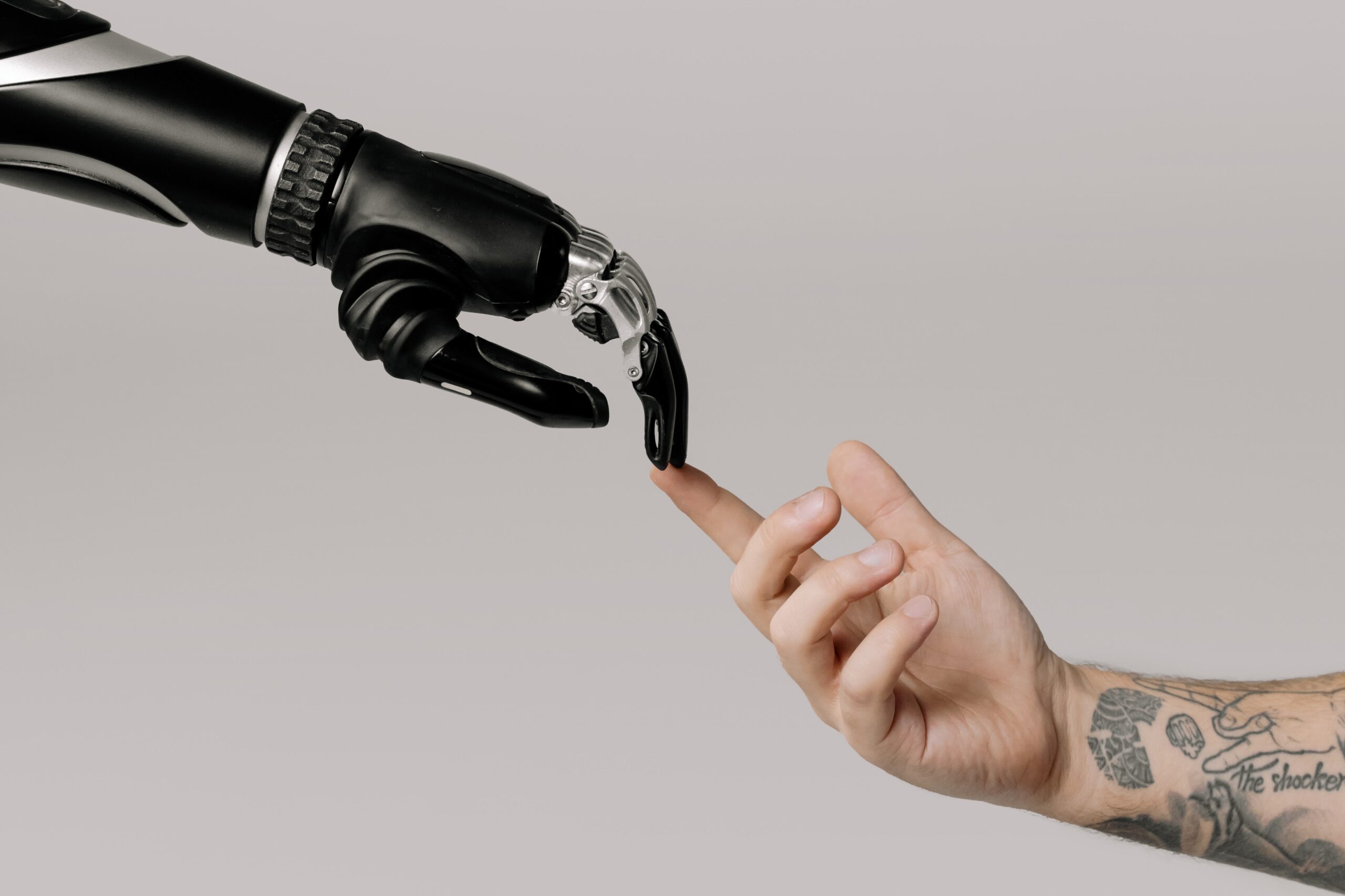 Robotic hand touching a person's hand