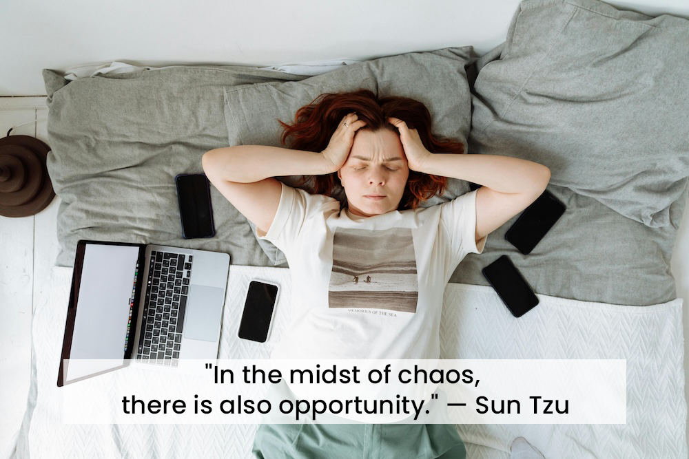 photo of a person on a bed holding their head with the quote "In the midst of chaos, there is also opportunity." — Sun Tzu